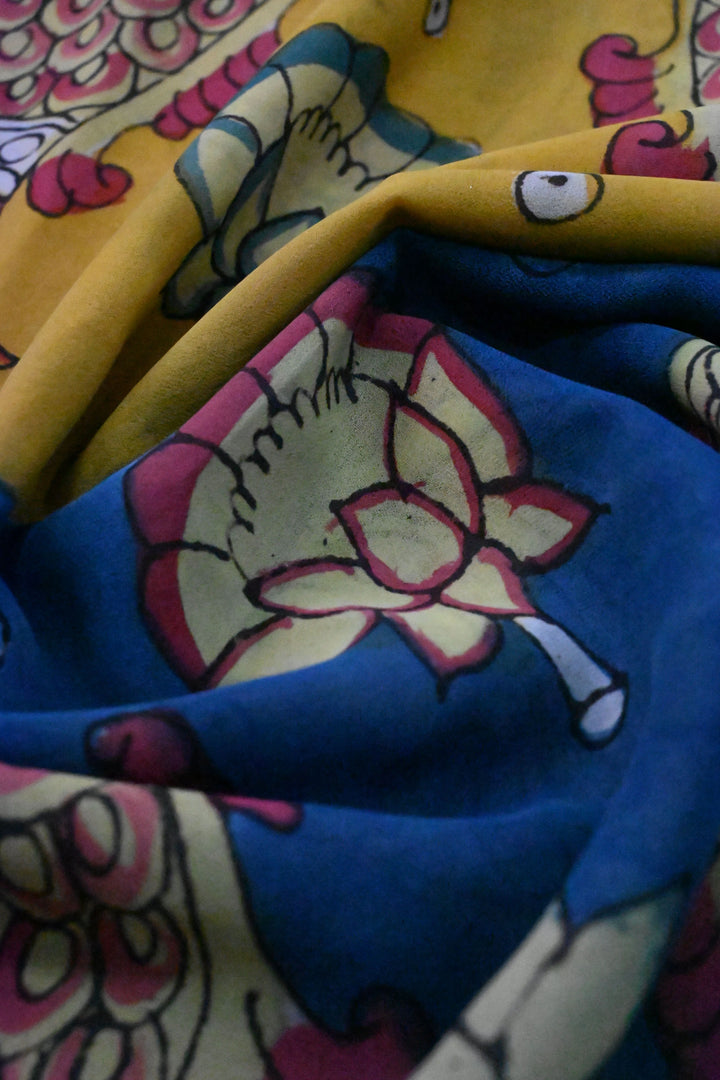 Floral and Matsya Theme : Yellow and Blue Authentic Pen Kalamkari on Banarasi Pure Georgette Saree with Fancy Lace Border  | SILK MARK CERTIFIED | SHOBITAM