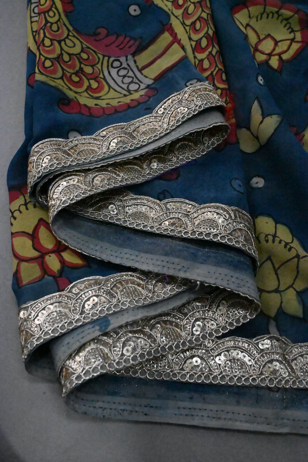 Floral and Matsya Theme : Yellow and Blue Authentic Pen Kalamkari on Banarasi Pure Georgette Saree with Fancy Lace Border  | SILK MARK CERTIFIED | SHOBITAM