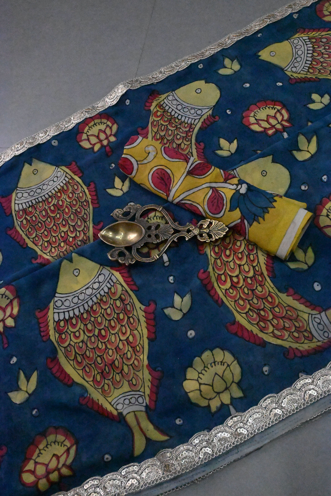 Floral and Matsya Theme : Yellow and Blue Authentic Pen Kalamkari on Banarasi Pure Georgette Saree with Fancy Lace Border  | SILK MARK CERTIFIED | SHOBITAM