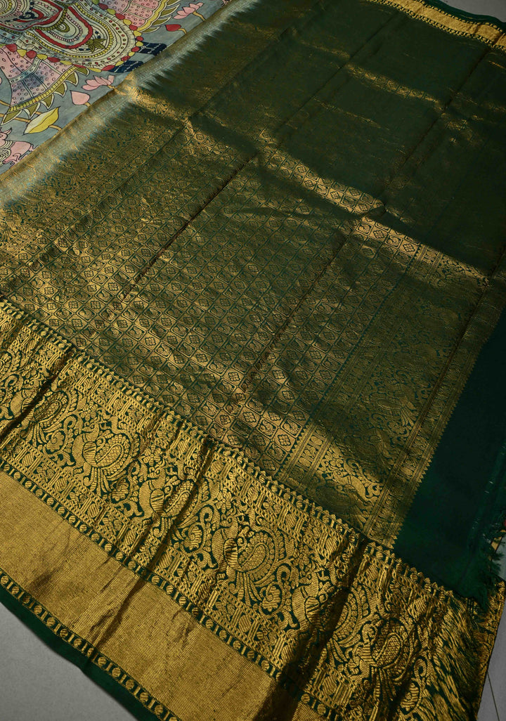 Pichwai and Srinathji Theme :  Authentic Pen Kalamkari Handpainted on Pure Kanjivaram Silk Saree with Contrast Zari Border | SILK MARK CERTIFIED | SHOBITAM