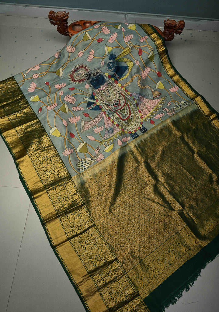 Pichwai and Srinathji Theme :  Authentic Pen Kalamkari Handpainted on Pure Kanjivaram Silk Saree with Contrast Zari Border | SILK MARK CERTIFIED | SHOBITAM