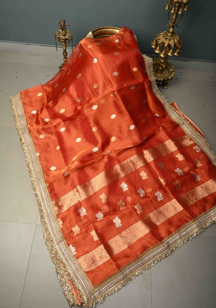 Orange Pure Banarasi Organza Tissue Silk Saree with Sona Rupa Floral Zari Buttas and Fancy Trim Lace Border | SILK MARK CERTIFIED | SHOBITAM