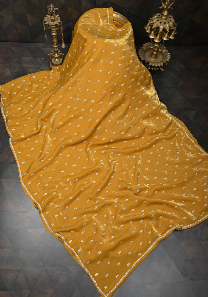 Ochre shimmer Georgette saree with stone buttas and minimal borders
