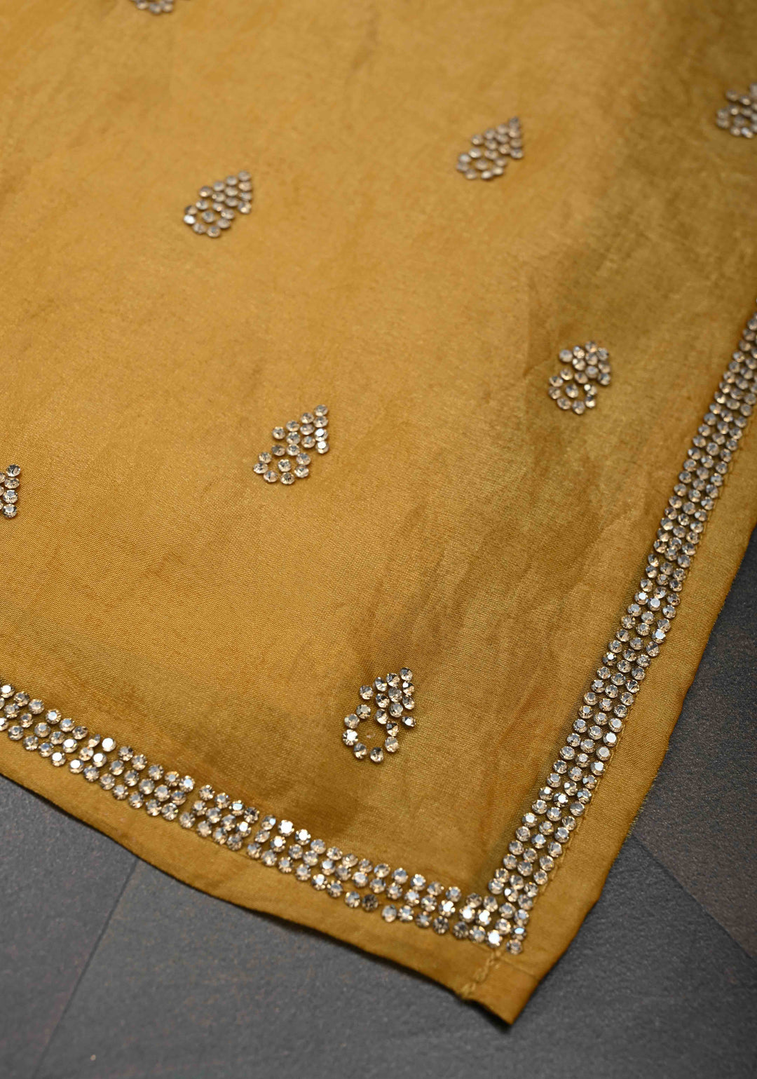 Ochre shimmer Georgette saree with stone buttas and minimal borders