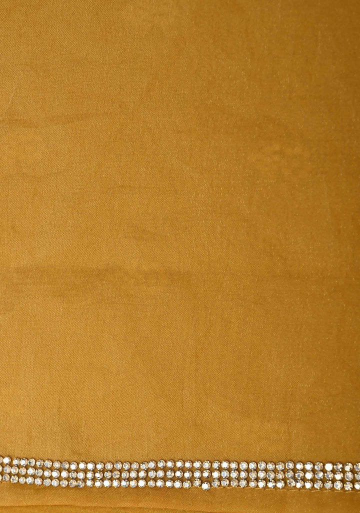 Ochre shimmer Georgette saree with stone buttas and minimal borders