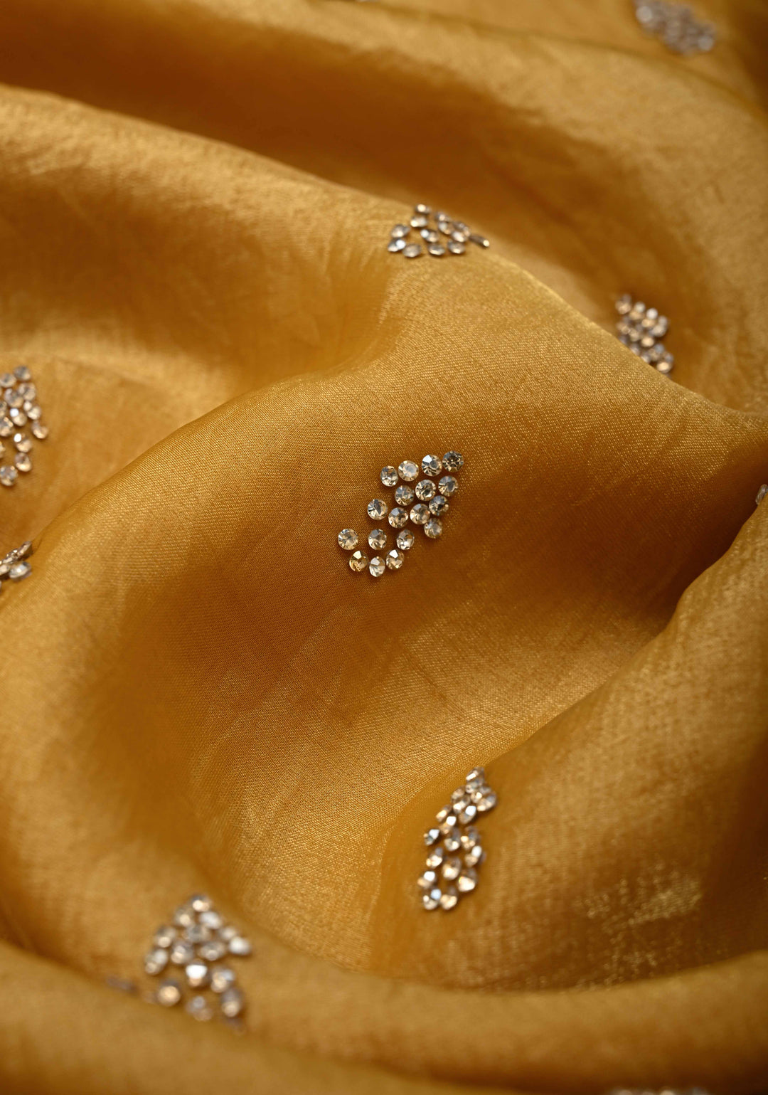 Ochre shimmer Georgette saree with stone buttas and minimal borders