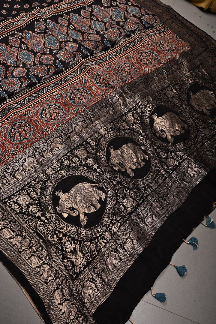 Black Ajrakh Hand Block Print on Dola Silk Saree with Fancy Zari Border | SHOBITAM