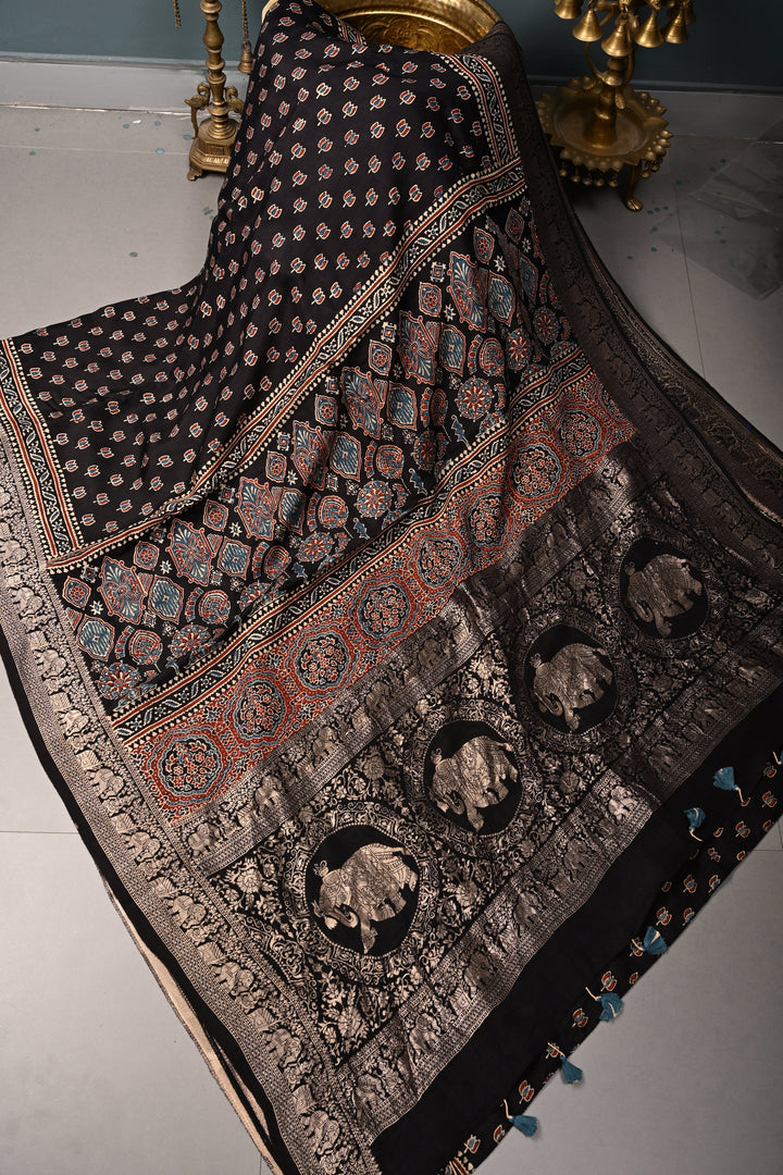 Black Ajrakh Hand Block Print on Dola Silk Saree with Fancy Zari Border | SHOBITAM