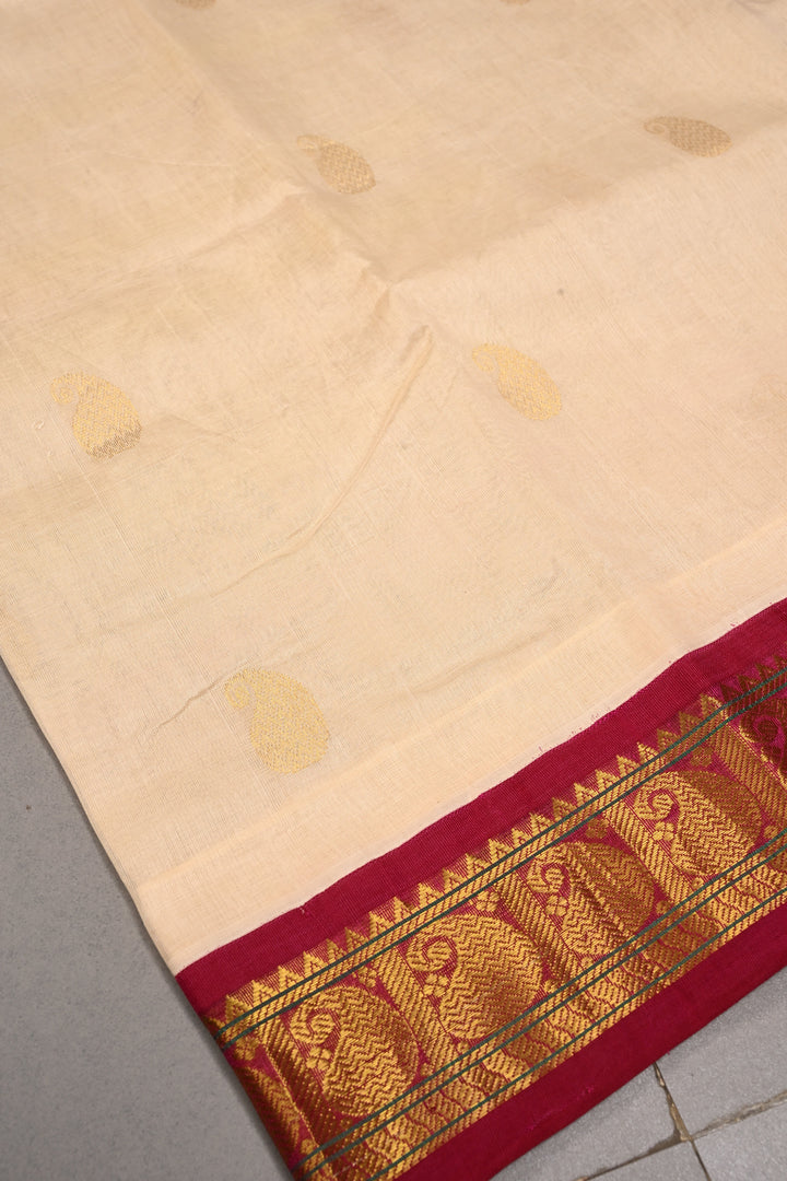 Off White Kanchi Silk Cotton Handloom Saree with Paisley Zari Buttas and Contrast Zari Border | SHOBITAM