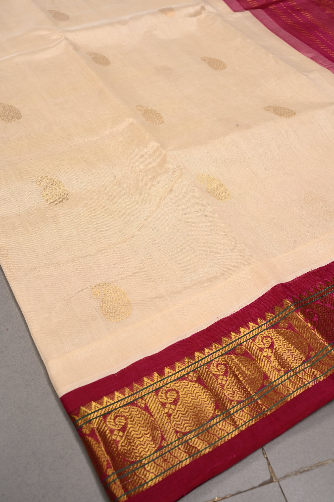 Off White Kanchi Silk Cotton Handloom Saree with Paisley Zari Buttas and Contrast Zari Border | SHOBITAM
