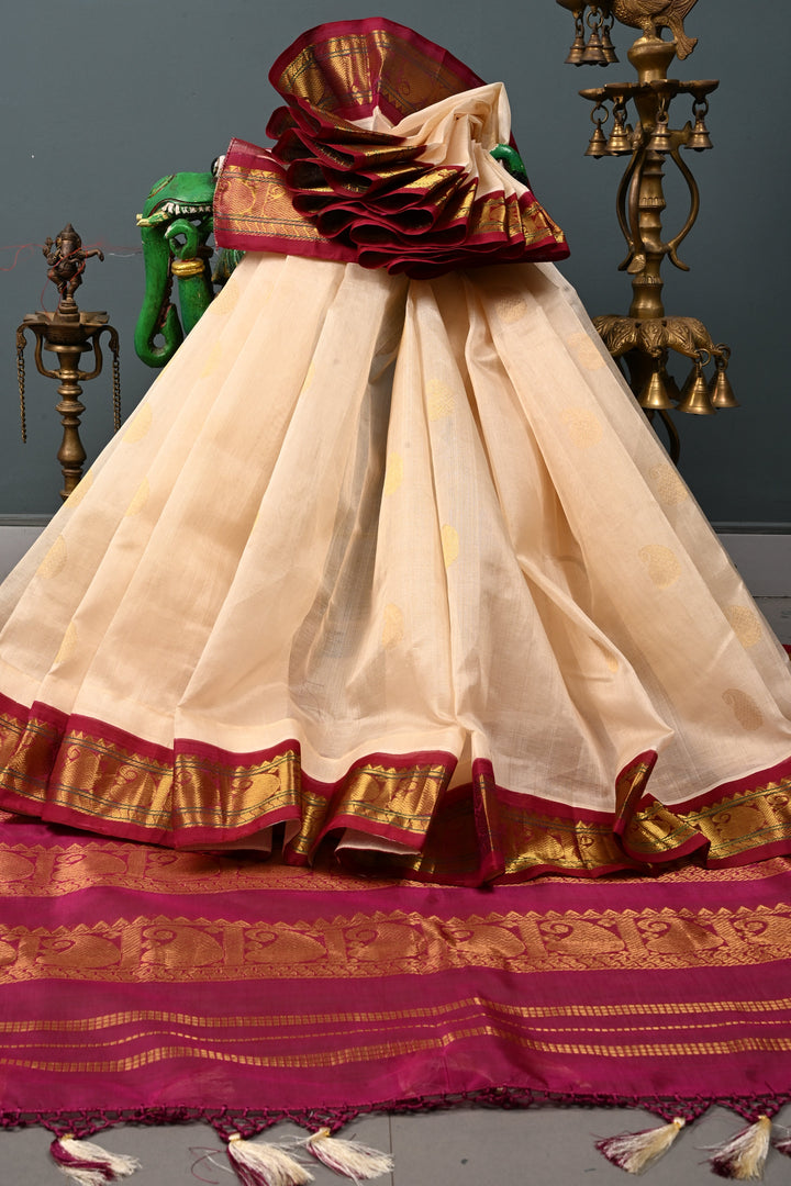 Off White Kanchi Silk Cotton Handloom Saree with Paisley Zari Buttas and Contrast Zari Border | SHOBITAM