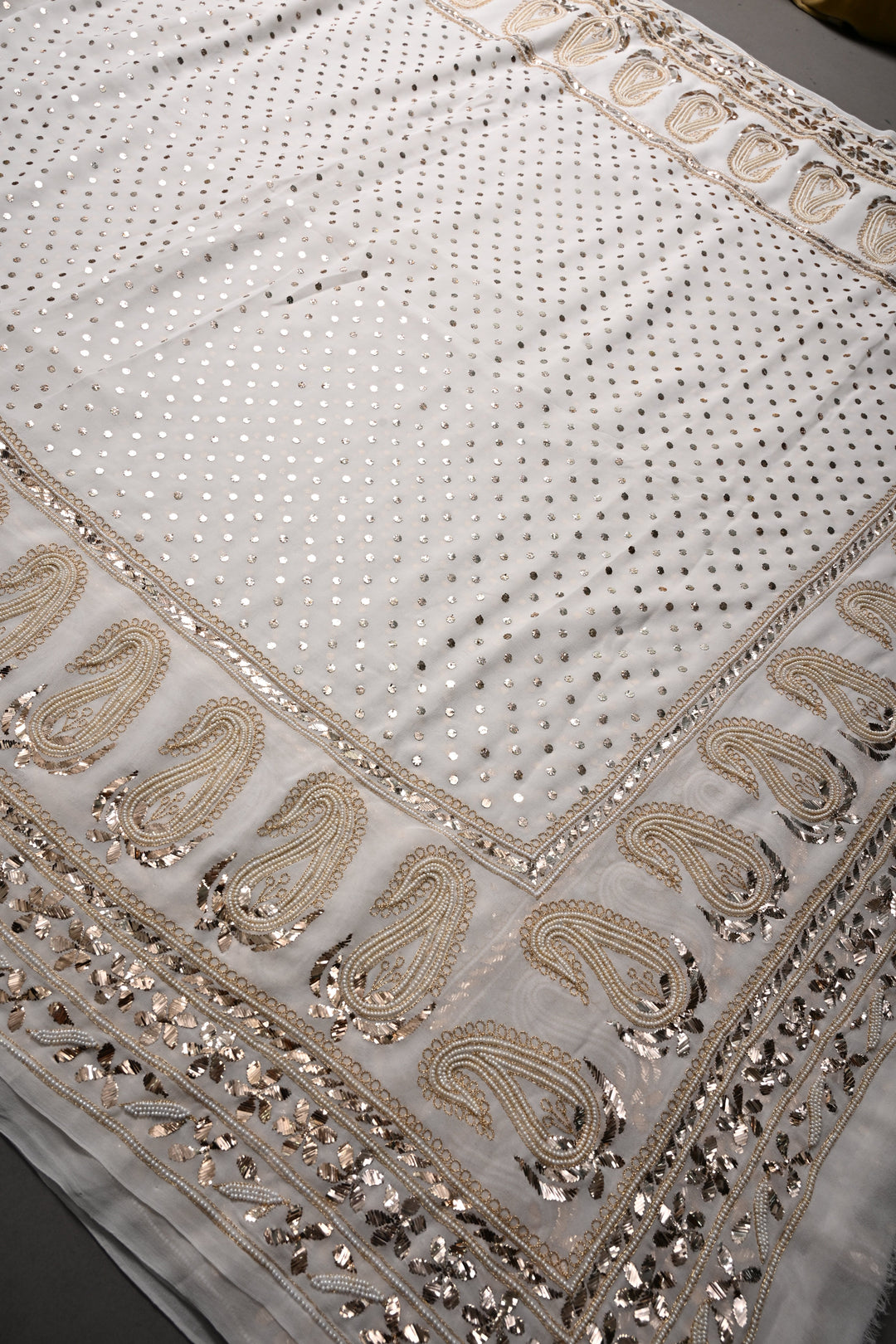 Exquisite Celebrity Mukeish and Moti Handwork Embellished on Pure Georgette Saree in White with Paisley Border | SHOBITAM