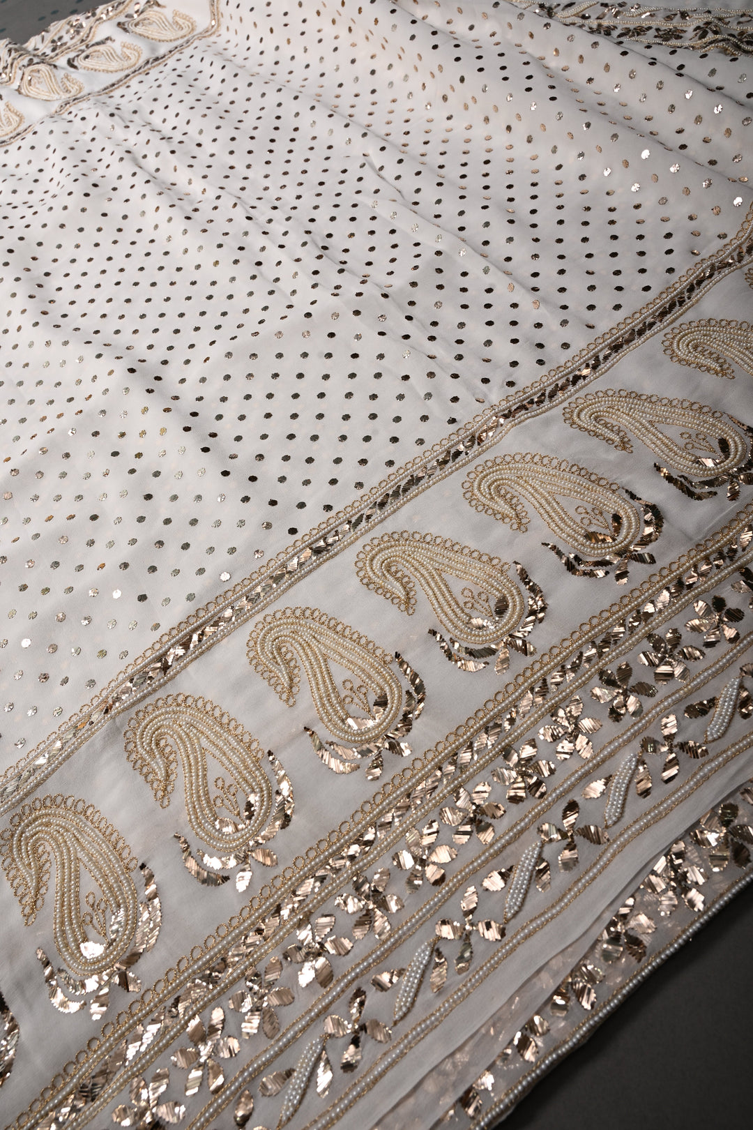 Exquisite Celebrity Mukeish and Moti Handwork Embellished on Pure Georgette Saree in White with Paisley Border | SHOBITAM