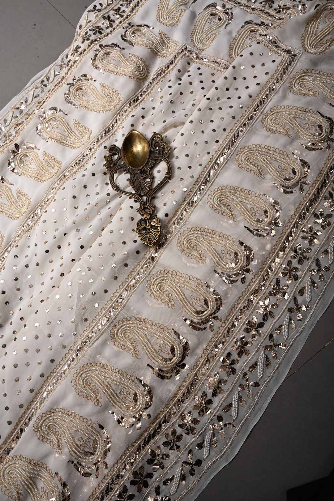 Exquisite Celebrity Mukeish and Moti Handwork Embellished on Pure Georgette Saree in White with Paisley Border | SHOBITAM
