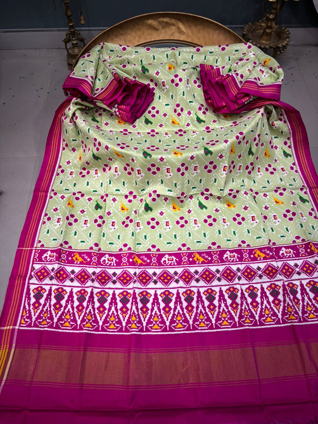 Authentic Double Ikkat Patan Patola Pure Silk Handwoven Patli Pallu Saree in Light Pista Green with Leheria Design and Pink Border | SILK MARK CERTIFIED | SHOBITAM
