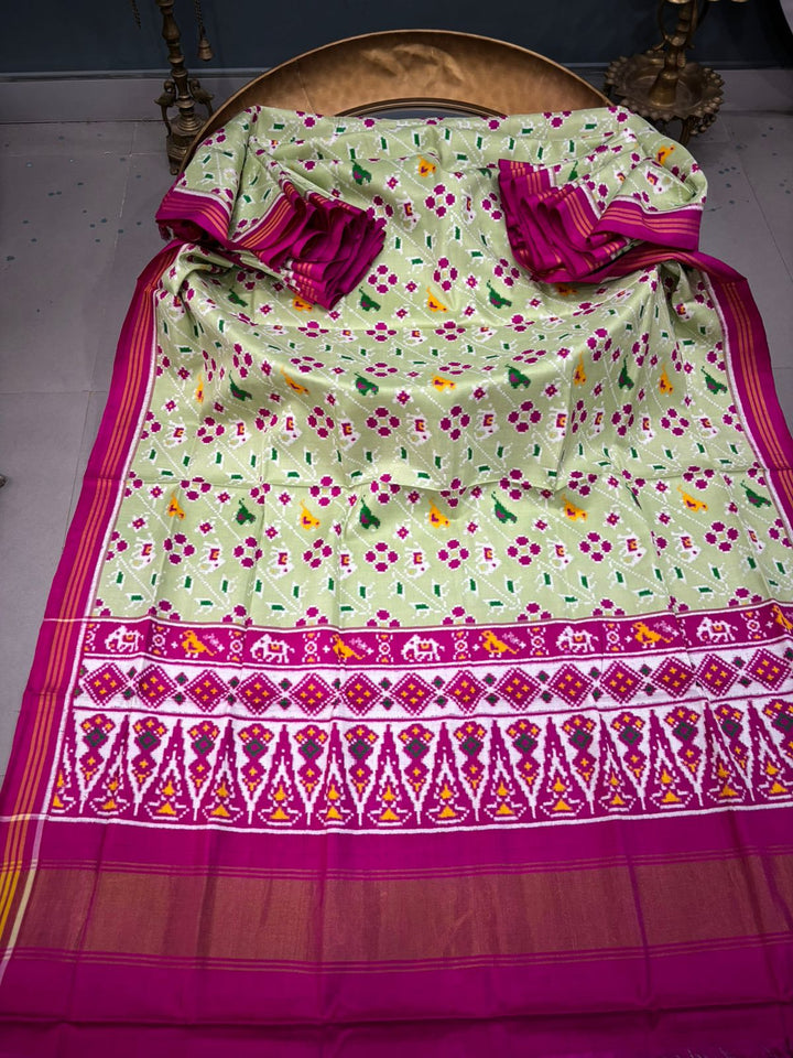Authentic Double Ikkat Patan Patola Pure Silk Handwoven Patli Pallu Saree in Light Pista Green with Leheria Design and Pink Border | SILK MARK CERTIFIED | SHOBITAM