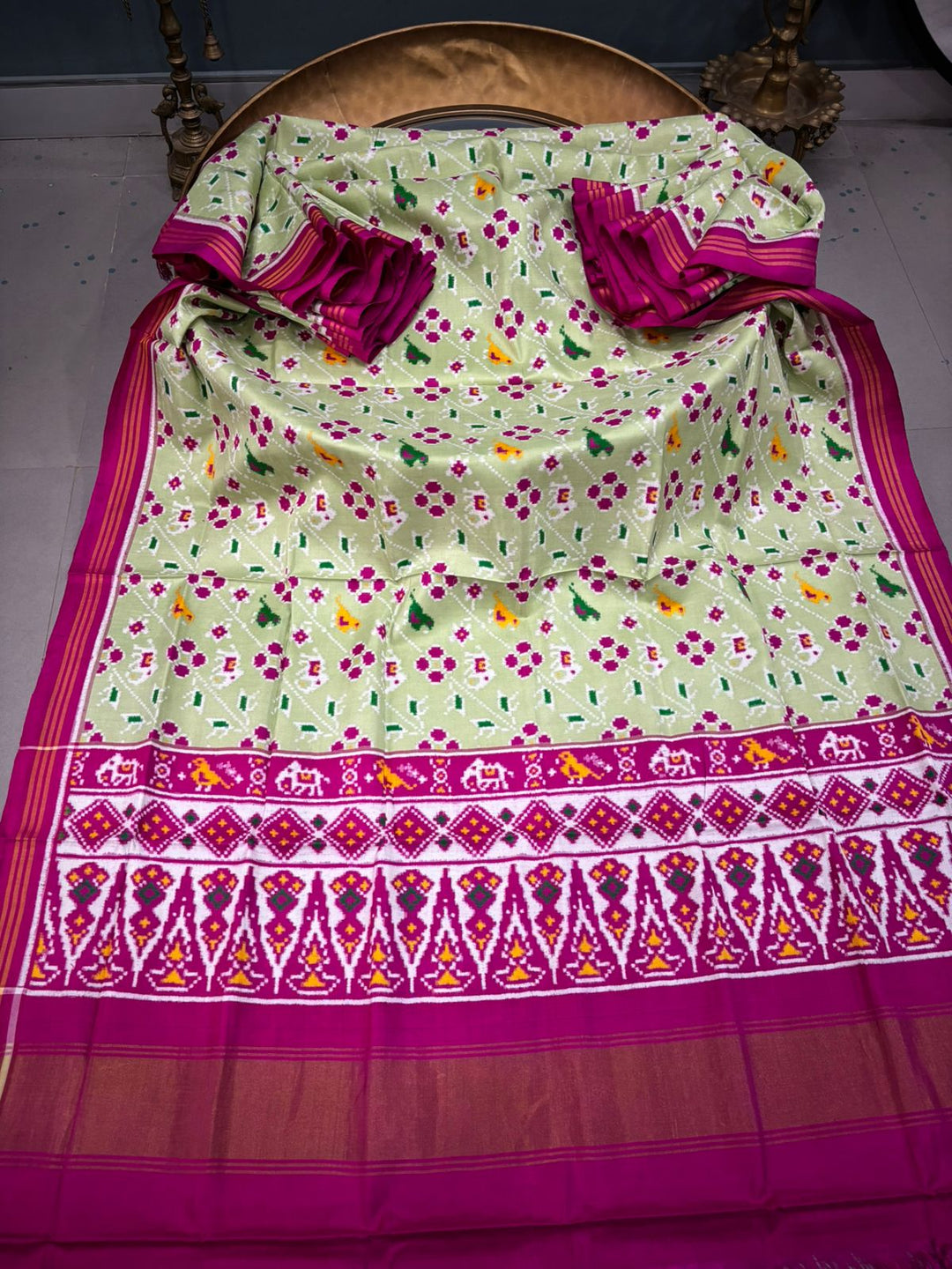 Authentic Double Ikkat Patan Patola Pure Silk Handwoven Patli Pallu Saree in Light Pista Green with Leheria Design and Pink Border | SILK MARK CERTIFIED | SHOBITAM