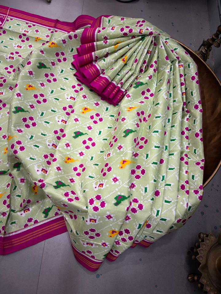 Authentic Double Ikkat Patan Patola Pure Silk Handwoven Patli Pallu Saree in Light Pista Green with Leheria Design and Pink Border | SILK MARK CERTIFIED | SHOBITAM