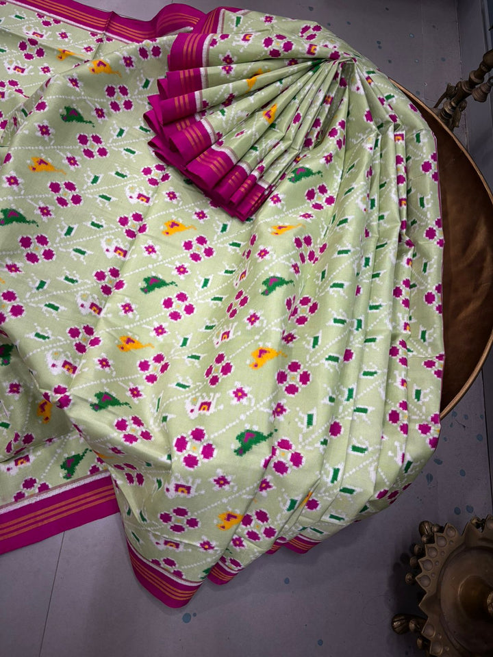 Authentic Double Ikkat Patan Patola Pure Silk Handwoven Patli Pallu Saree in Light Pista Green with Leheria Design and Pink Border | SILK MARK CERTIFIED | SHOBITAM