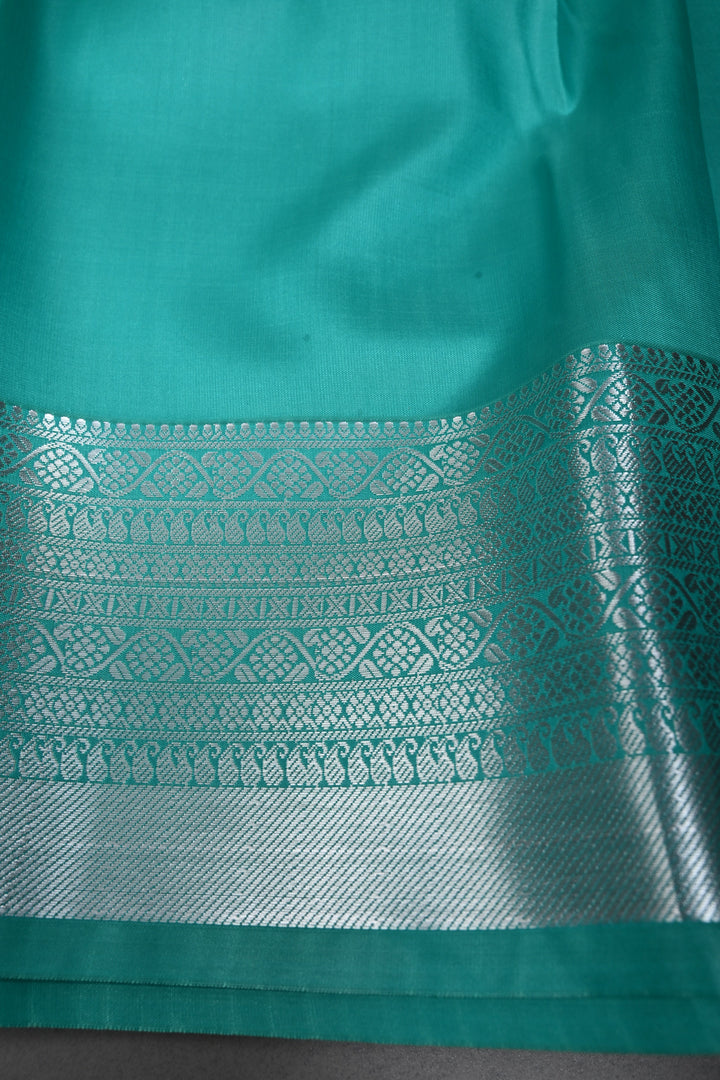 Sea Green Kanjivaram Soft Semi Silk Saree with Floral Brocade and Silver Zari Border | SHOBITAM