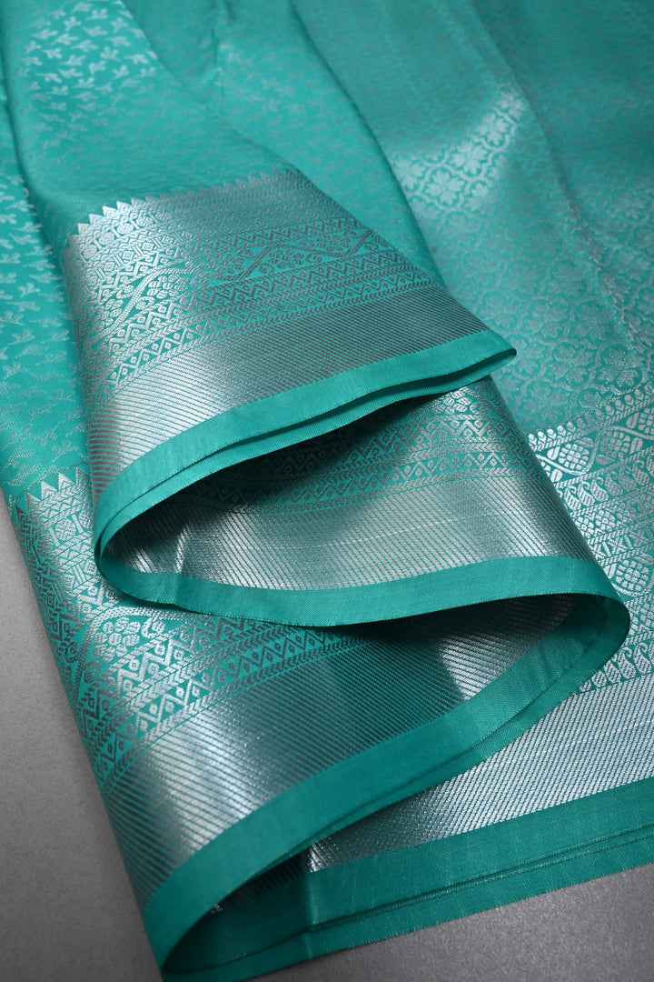 Sea Green Kanjivaram Soft Semi Silk Saree with Floral Brocade and Silver Zari Border | SHOBITAM