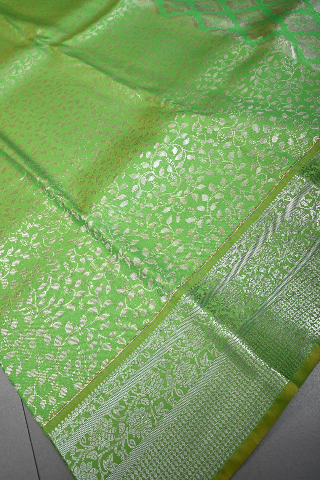 Parrot Green Kanjivaram Soft Semi Silk Saree with Floral Brocade Jaal and Silver Zari Border | SHOBITAM