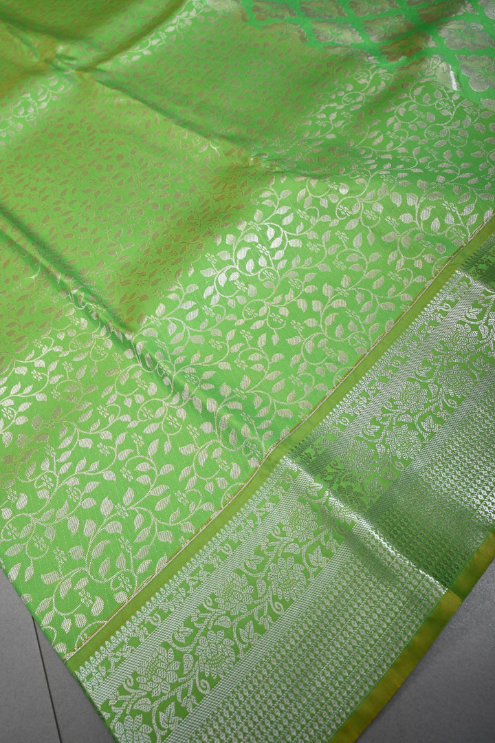 Parrot Green Kanjivaram Soft Semi Silk Saree with Floral Brocade Jaal and Silver Zari Border | SHOBITAM