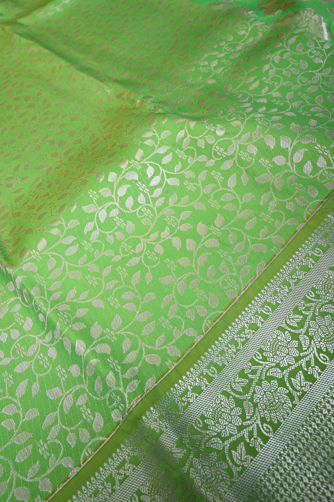 Parrot Green Kanjivaram Soft Semi Silk Saree with Floral Brocade Jaal and Silver Zari Border | SHOBITAM