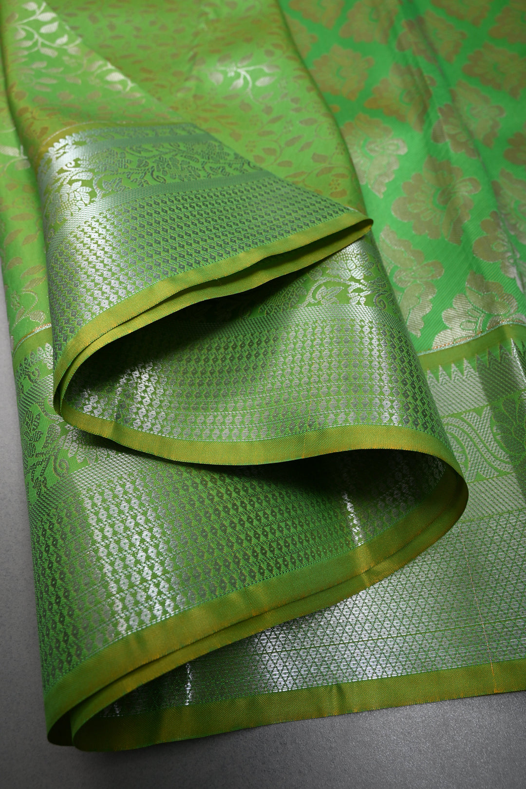 Parrot Green Kanjivaram Soft Semi Silk Saree with Floral Brocade Jaal and Silver Zari Border | SHOBITAM