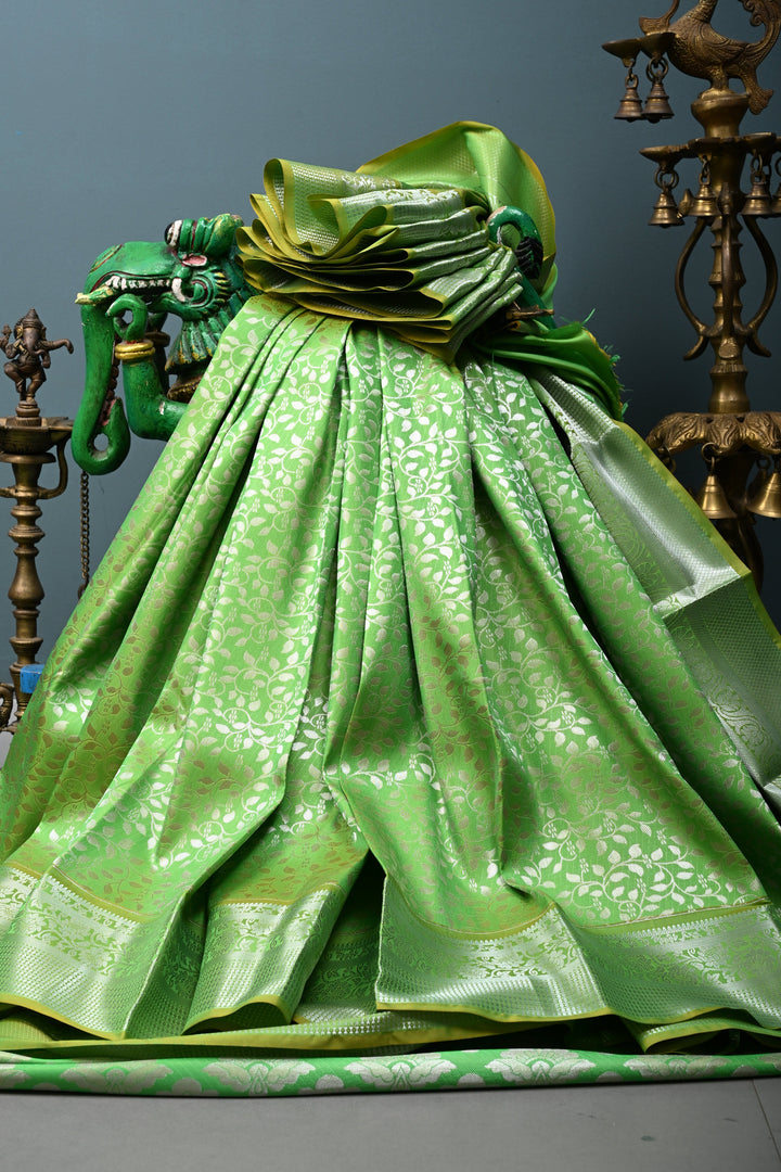 Parrot Green Kanjivaram Soft Semi Silk Saree with Floral Brocade Jaal and Silver Zari Border | SHOBITAM
