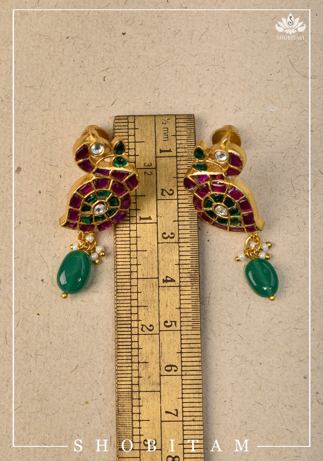 Handcrafted Jadau Peacock Earrings in Pink ,Green and  White color with dangling Green Bead | Shobitam Jewelry