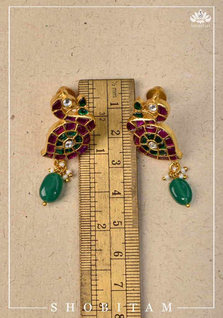 Handcrafted Jadau Peacock Earrings in Pink ,Green and  White color with dangling Green Bead | Shobitam Jewelry