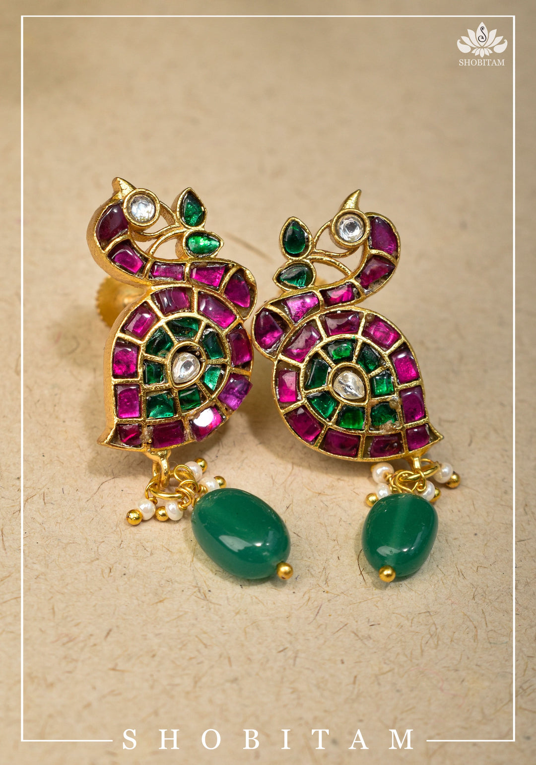 Handcrafted Jadau Peacock Earrings in Pink ,Green and  White color with dangling Green Bead | Shobitam Jewelry