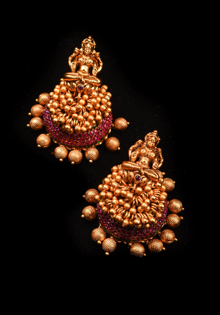 Traditional Antique Finish Gold Lakshmi Jhumkas with powder red stones and Gold Beads