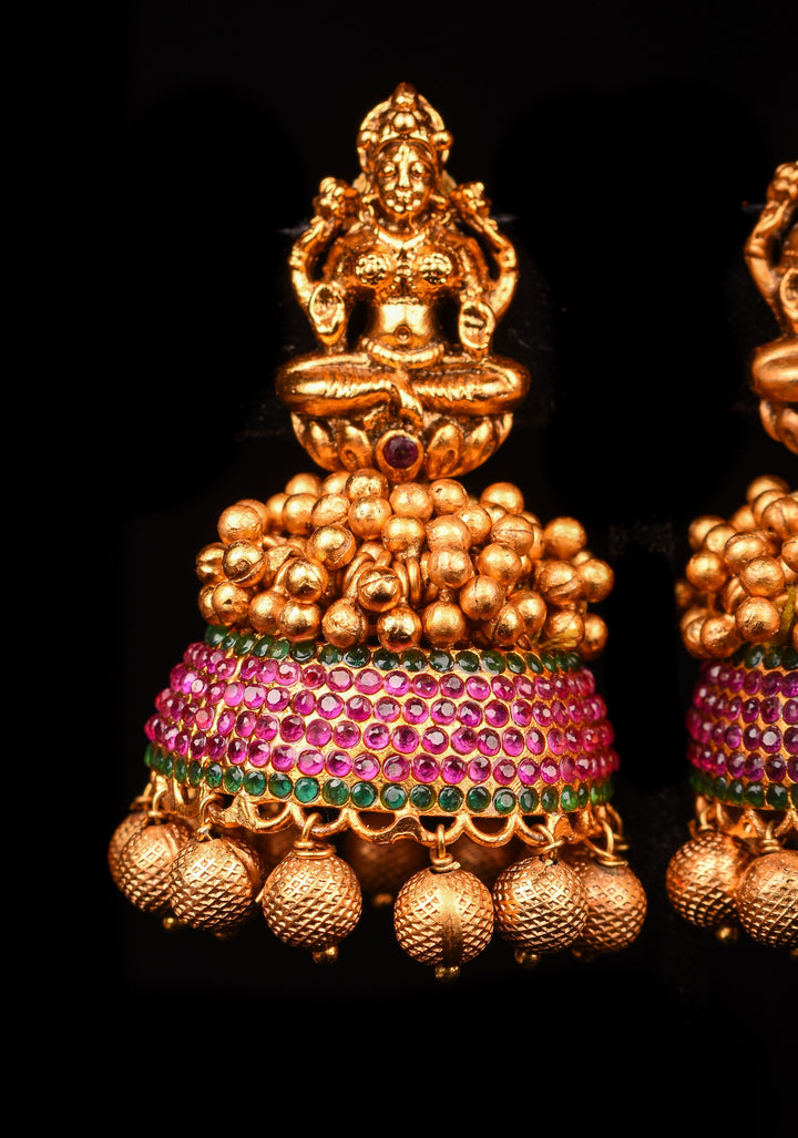 Traditional Antique Finish Gold Lakshmi Jhumkas with powder red stones and Gold Beads