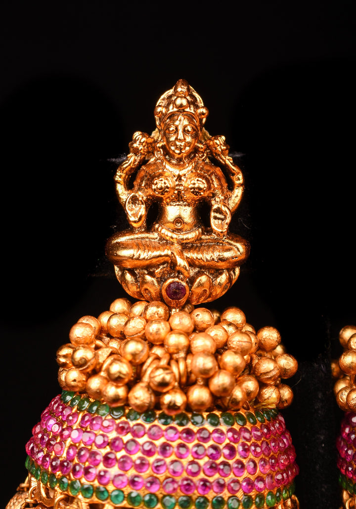 Traditional Antique Finish Gold Lakshmi Jhumkas with powder red stones and Gold Beads