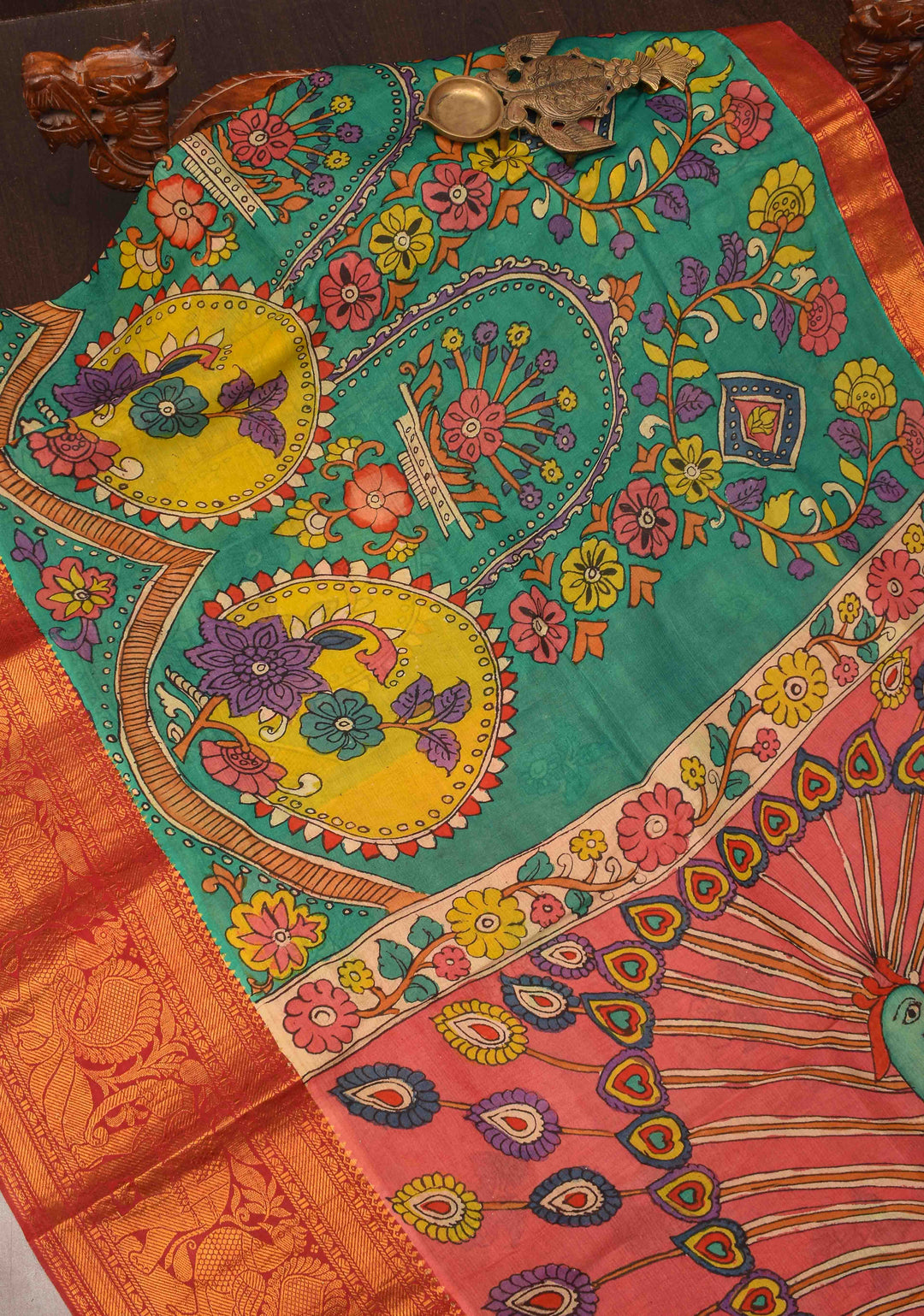 Floral Theme : Teal Authentic Pen kalamkari on pure Chennuri Silk Saree with zari border and Peacock motif on Pallu