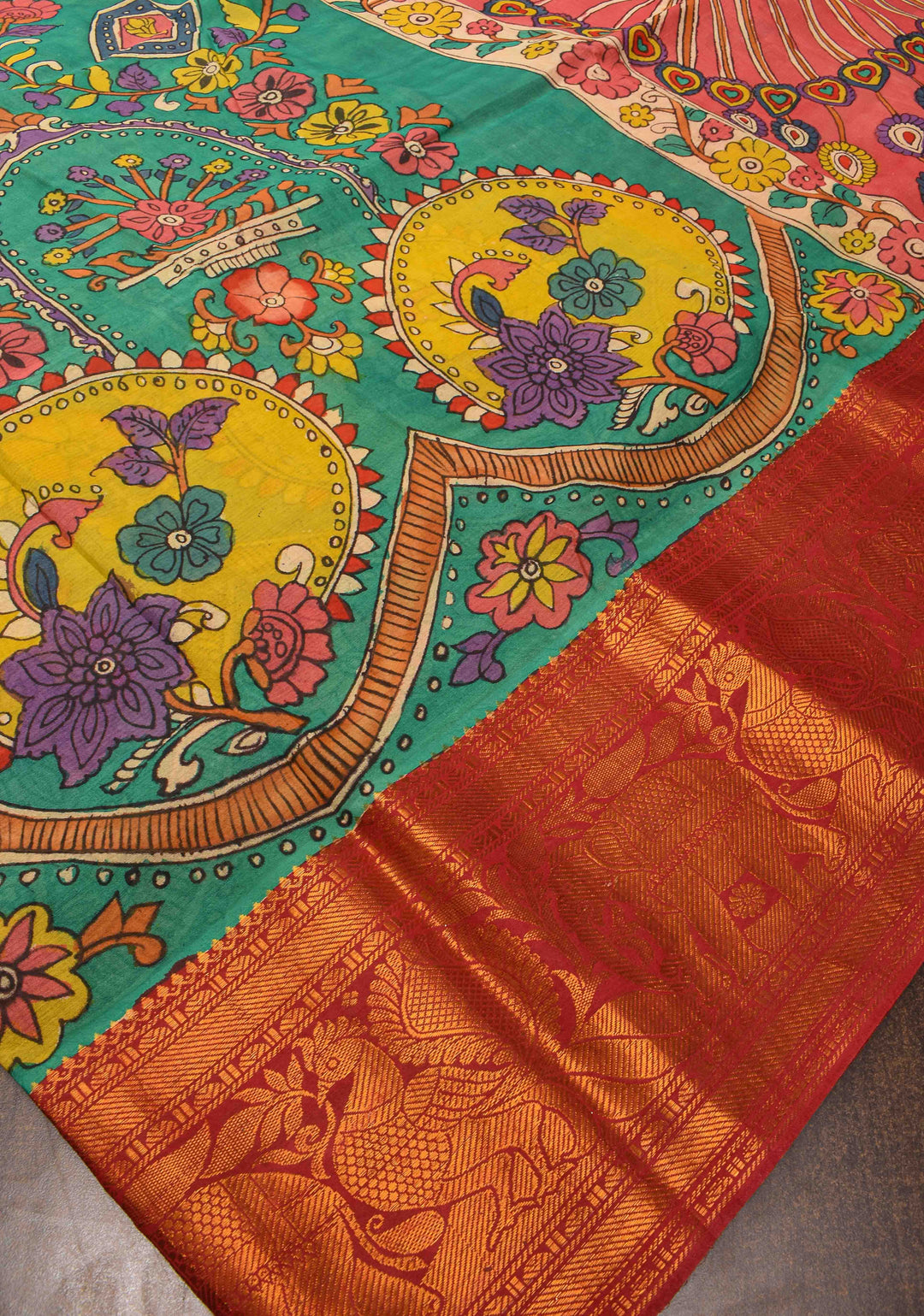 Floral Theme : Teal Authentic Pen kalamkari on pure Chennuri Silk Saree with zari border and Peacock motif on Pallu