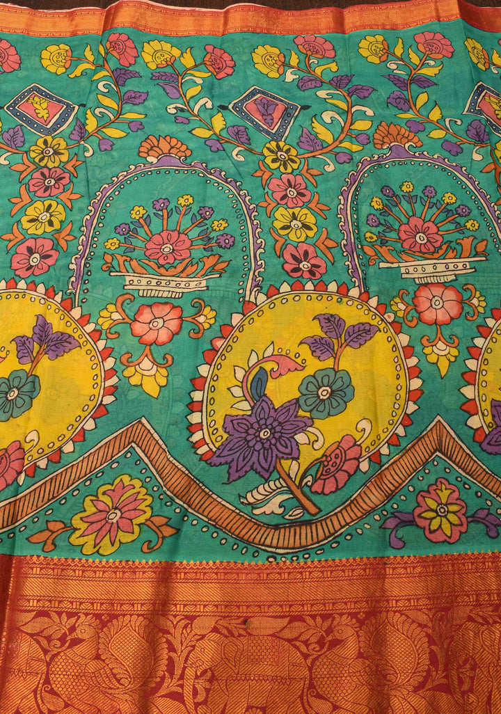 Floral Theme : Teal Authentic Pen kalamkari on pure Chennuri Silk Saree with zari border and Peacock motif on Pallu