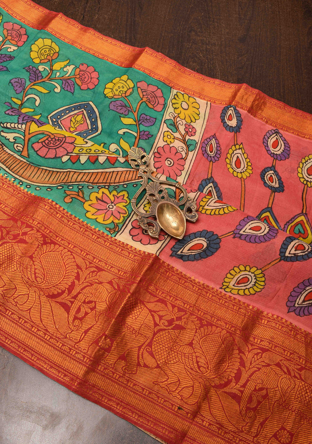 Floral Theme : Teal Authentic Pen kalamkari on pure Chennuri Silk Saree with zari border and Peacock motif on Pallu