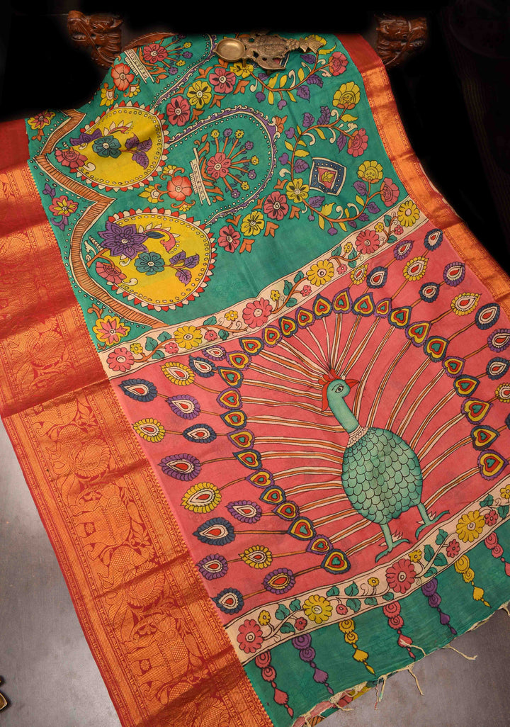 Floral Theme : Teal Authentic Pen kalamkari on pure Chennuri Silk Saree with zari border and Peacock motif on Pallu
