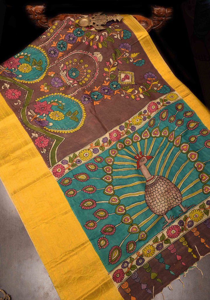 Floral Theme : Brown Authentic Pen kalamkari on Bangalore Silk Saree with zari border and Peacock motif on Pallu