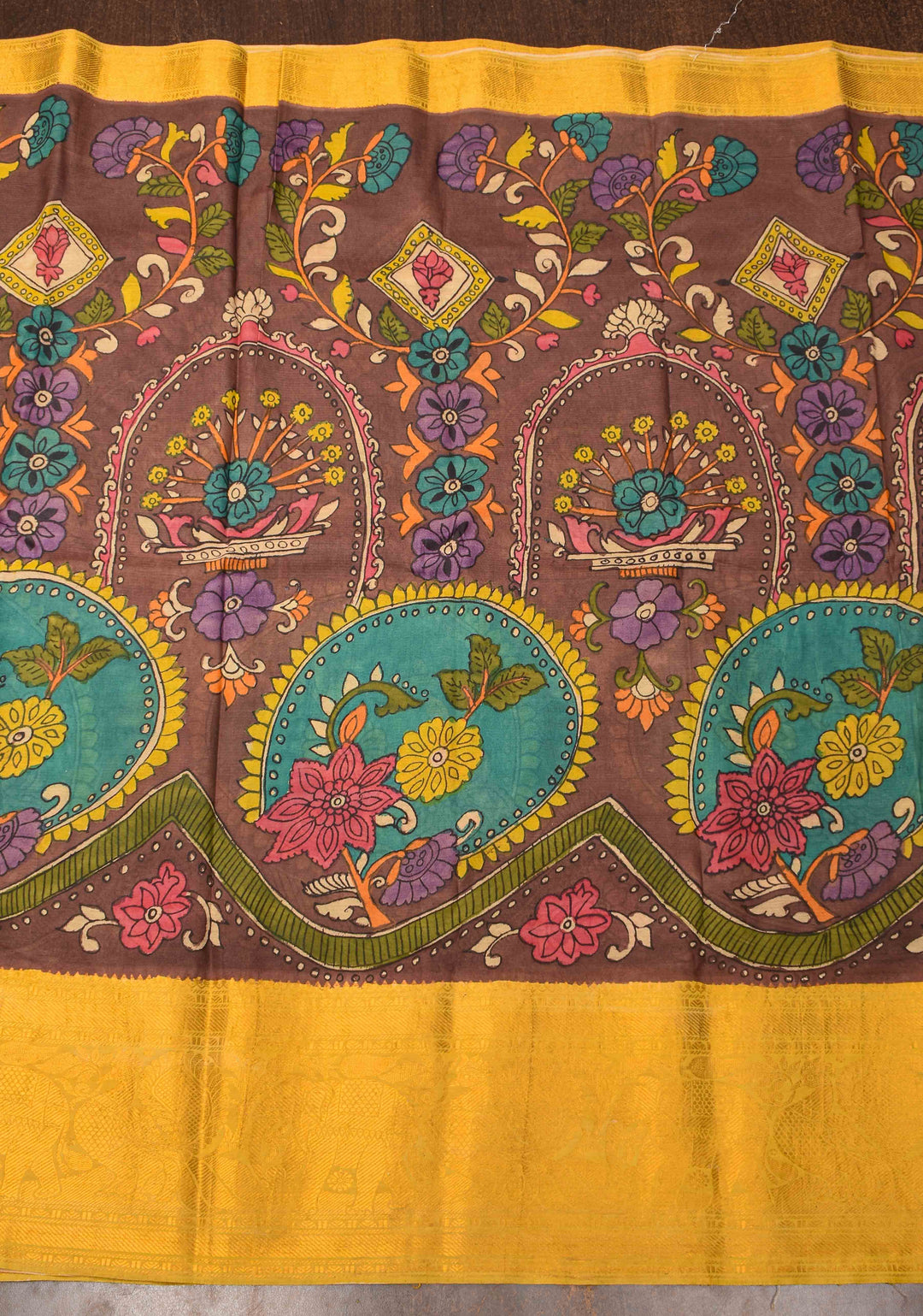 Floral Theme : Brown Authentic Pen kalamkari on Bangalore Silk Saree with zari border and Peacock motif on Pallu