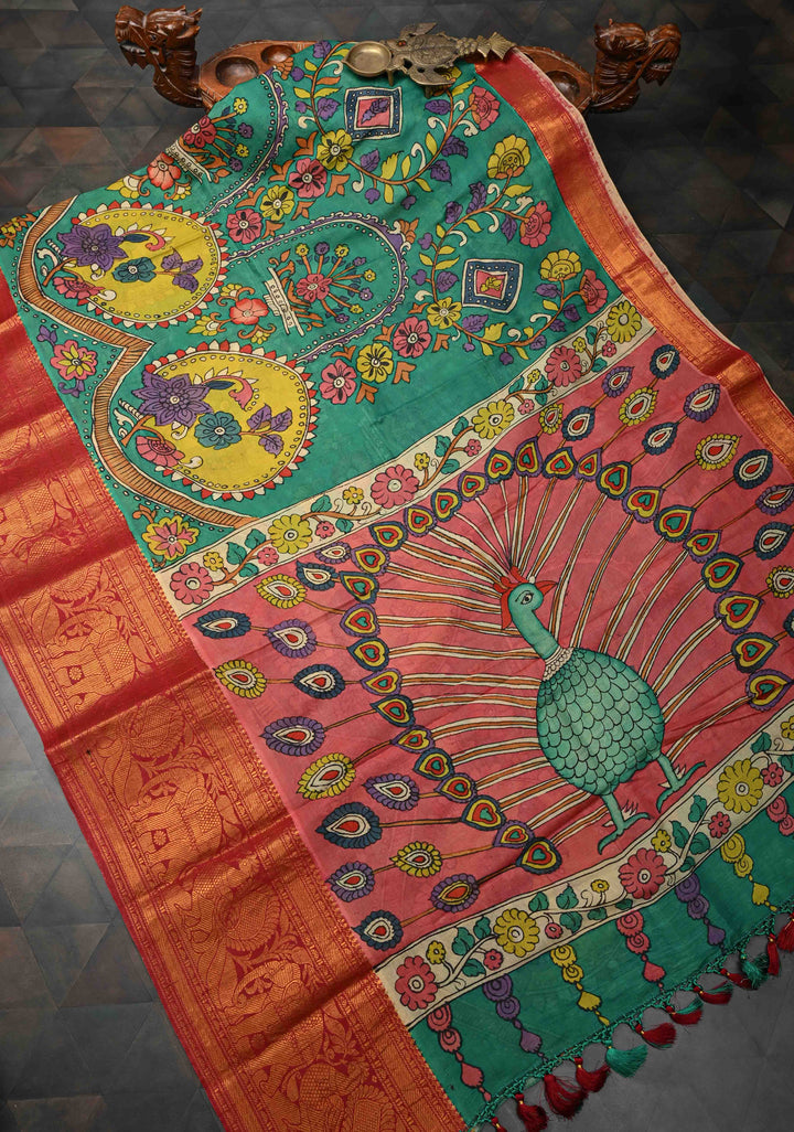 Floral and Peacock Theme : Green Authentic Pen kalamkari on Pure Chennuri Silk Saree with Wide Zari Border