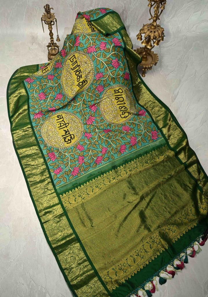 Nari Shakti and Floral Theme  : Turquoise Authentic Pen Kalamkari on Pure Kanjivaram Silk Saree with Bottle Green Zari Border | SILK MARK CERTIFIED