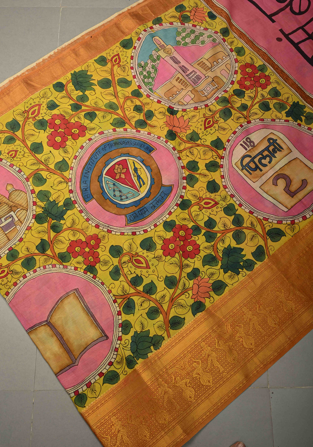 Pilani Campus Life Theme: Yellow Authentic Pen kalamkari on Bangalore Silk Saree with Zari Border and Jnanam Paramam Balam on Pallu | SHOBITAM