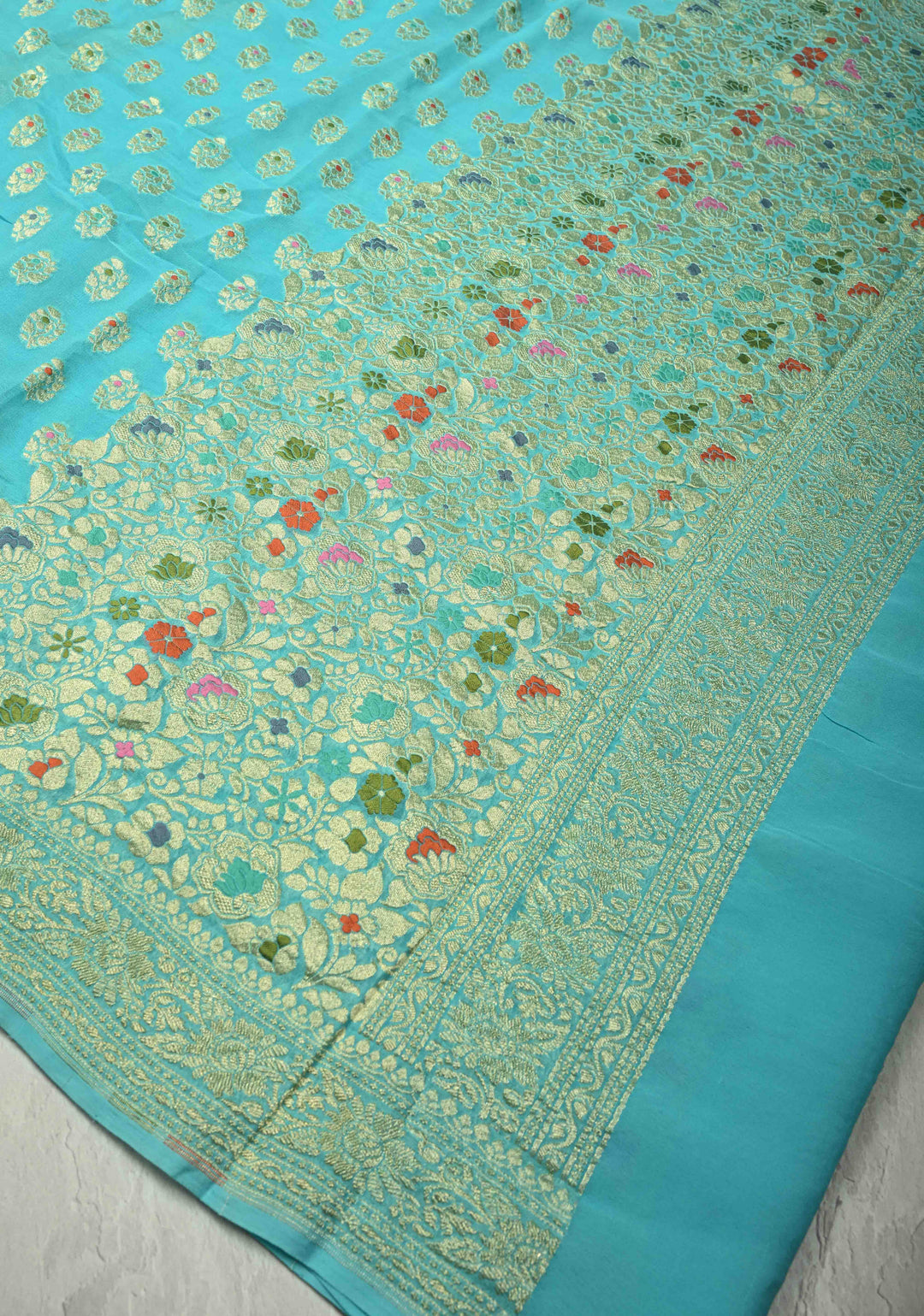Authentic Turquoise Meenakari Work on Banarasi Silk Georgette Saree with Floral Buttas and 2 Side Equal Ornate Skirt Border | SILK MARK CERTIFIED