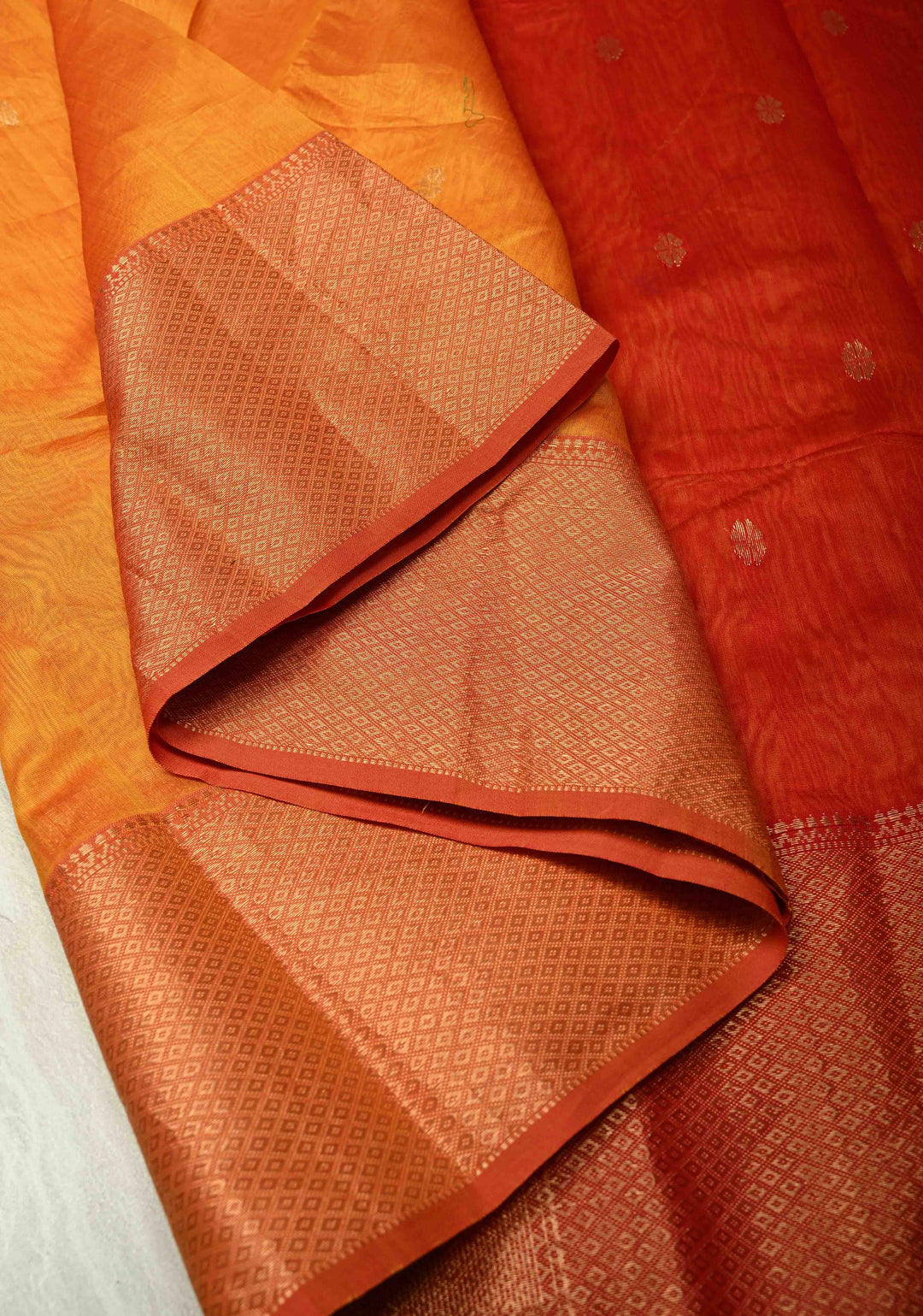 Yellowish Orange Dual Tone Handwoven Maheshwari Silk Cotton Saree with Resham Buttas and Contrast Border