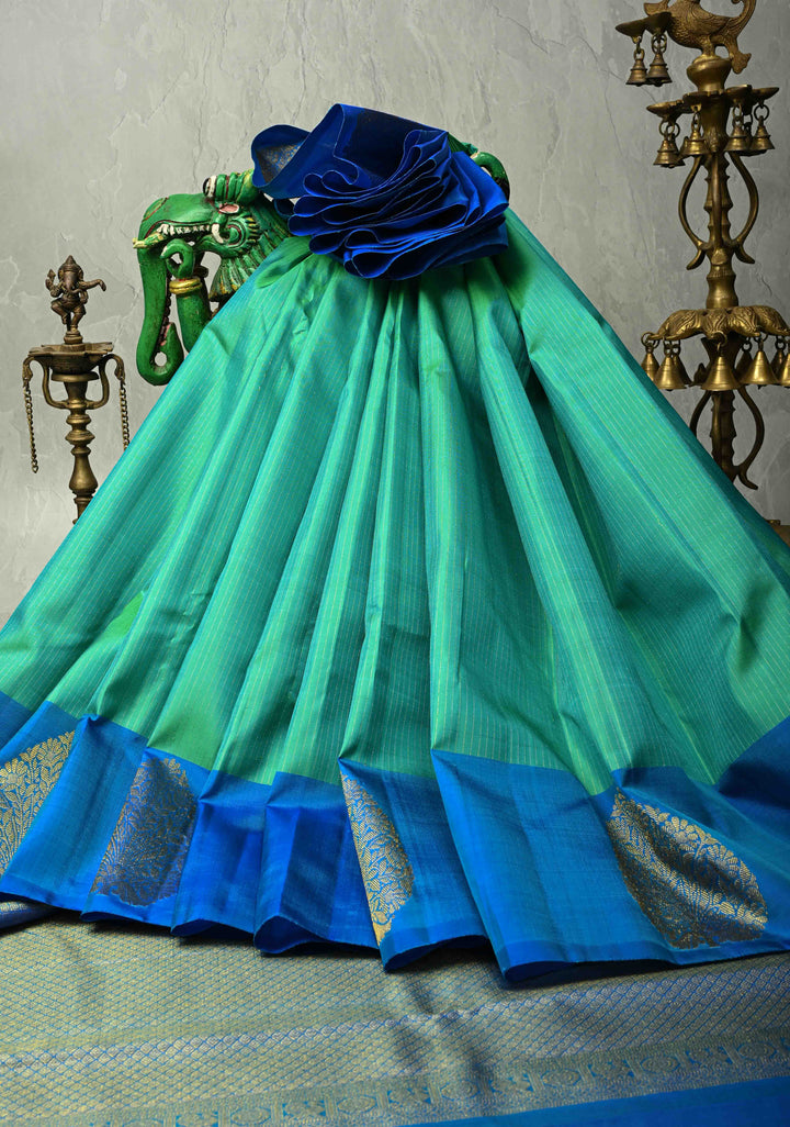 Sea Green Dual tone Pure Kanjivaram Silk Handloom Saree with Vairaoosi Zari Stripes and Distinct Tree Motifs on Contrast Border  | SILK MARK CERTIFIED