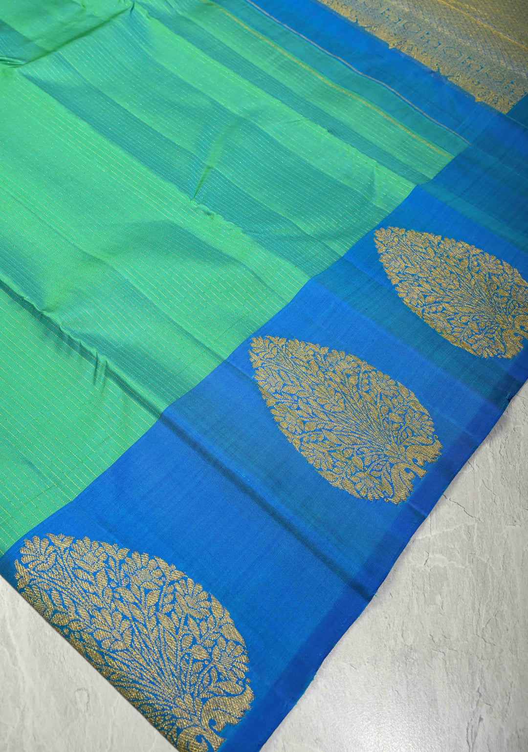 Green-Blue Dual Tone Pure Kanjivaram Silk Handloom Saree with Vairaoosi Zari Stripes and Distinct Floral Motifs on Contrast Border | SILK MARK CERTIFIED